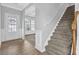 Welcoming entryway with paneled walls, hardwood floors and stairway leading upstairs at 209 Woodmill Sw Way, Atlanta, GA 30331