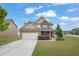 Two-story home with a two-car garage and well-manicured lawn on a partly cloudy day at 209 Woodmill Sw Way, Atlanta, GA 30331