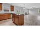 Well-lit kitchen features stainless steel appliances, an island, granite countertops, and opens to the living room at 209 Woodmill Sw Way, Atlanta, GA 30331