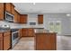 Well-lit kitchen features stainless steel appliances, granite countertops and an island that opens to the living room at 209 Woodmill Sw Way, Atlanta, GA 30331