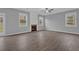 Spacious living room with fireplace, windows, ceiling fan, and wood flooring at 209 Woodmill Sw Way, Atlanta, GA 30331