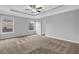 Spacious main bedroom boasts neutral walls, carpeted floor and a tray ceiling with fan at 209 Woodmill Sw Way, Atlanta, GA 30331