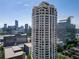 A tall modern high-rise building with a sleek design against a backdrop of the city at 3475 Oak Valley Ne Rd # 2940, Atlanta, GA 30326