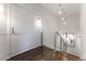 Stylish hallway with wood floors, glass railing, modern lighting, and decorative wall paneling offering a clean aesthetic at 3475 Oak Valley Ne Rd # 2940, Atlanta, GA 30326