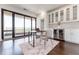 Bright home office with hardwood floors, balcony access, and stylish built-in cabinets with a wine cooler at 3475 Oak Valley Ne Rd # 2940, Atlanta, GA 30326