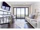 Cozy living room featuring dark hardwood floors, a TV, and a balcony with great views at 3475 Oak Valley Ne Rd # 2940, Atlanta, GA 30326