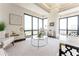 Bright living room with large windows, stylish decor, and comfortable seating creating a welcoming atmosphere at 3475 Oak Valley Ne Rd # 2940, Atlanta, GA 30326