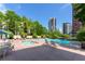 Relaxing pool area with lounge chairs, hot tub and city views at 3475 Oak Valley Ne Rd # 2940, Atlanta, GA 30326