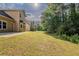 Over sized and meticulously maintained backyard with lush greenery, home, trees, and blue skies at 4995 Panola Mill Dr, Lithonia, GA 30038