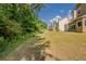 Well-maintained backyard with view of lawn, home, fence, pool, trees, and blue skies at 4995 Panola Mill Dr, Lithonia, GA 30038
