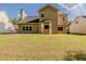Expansive backyard with a lush lawn, back of house featuring multiple windows and door with bay window at 4995 Panola Mill Dr, Lithonia, GA 30038