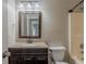 Traditional bathroom features a vanity with granite countertop and a wood-trimmed mirror at 4995 Panola Mill Dr, Lithonia, GA 30038