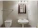 Half bathroom with pedestal sink, mirror and towel rack at 4995 Panola Mill Dr, Lithonia, GA 30038