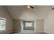Spacious bedroom with vaulted ceiling, carpeted floor, and multiple windows providing natural light at 4995 Panola Mill Dr, Lithonia, GA 30038