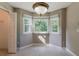 Inviting dining nook with sunny bay windows offering an abundance of natural light and a classic light fixture at 4995 Panola Mill Dr, Lithonia, GA 30038