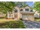 Charming two-story home featuring an attached two-car garage and a well-maintained front yard at 4995 Panola Mill Dr, Lithonia, GA 30038