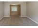 A carpeted living room area features neutral walls, white trim and an open layout to another room at 4995 Panola Mill Dr, Lithonia, GA 30038