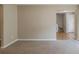 Bright living room features neutral walls, plush carpet, and entry to the next room at 4995 Panola Mill Dr, Lithonia, GA 30038