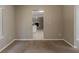 Carpeted living room with neutral walls that flows into the kitchen and another living space at 4995 Panola Mill Dr, Lithonia, GA 30038
