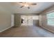 Open-concept living room with carpet, neutral walls, and view into the kitchen at 4995 Panola Mill Dr, Lithonia, GA 30038