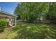 This home features a spacious backyard with lush green grass and mature trees at 5045 Edinborough Pl, Sugar Hill, GA 30518