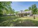 This home features a spacious backyard with lush green grass at 5045 Edinborough Pl, Sugar Hill, GA 30518