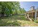 View of spacious backyard and covered patio at 5045 Edinborough Pl, Sugar Hill, GA 30518