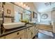 Elegant bathroom with dual sinks, a soaking tub, a walk-in shower, and stylish decor for a spa-like experience at 5045 Edinborough Pl, Sugar Hill, GA 30518