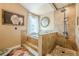 Luxurious bathroom featuring a soaking tub, a separate shower, tiled walls, and natural light creating a serene retreat at 5045 Edinborough Pl, Sugar Hill, GA 30518