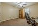 Bedroom with neutral walls, brown carpet, ceiling fan, and a wooden armoire at 5045 Edinborough Pl, Sugar Hill, GA 30518
