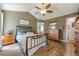 Comfortable bedroom with hardwood floors, a ceiling fan, and tasteful decor for a relaxing and stylish space at 5045 Edinborough Pl, Sugar Hill, GA 30518