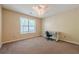 Bright bedroom with carpet, a ceiling fan, and natural light creating a serene atmosphere to relax and unwind at 5045 Edinborough Pl, Sugar Hill, GA 30518