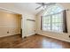Open dining area featuring hardwood floors, a large arched window, and seamless connectivity at 5045 Edinborough Pl, Sugar Hill, GA 30518