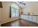 Bright dining area with hardwood floors, a large window, and ample natural light at 5045 Edinborough Pl, Sugar Hill, GA 30518