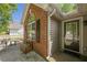 Inviting front entry with brick detail and a clear view of the door and surrounding landscape at 5045 Edinborough Pl, Sugar Hill, GA 30518