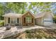 Charming home with a brick accent, fire pit, and patio, perfect for outdoor living and entertaining at 5045 Edinborough Pl, Sugar Hill, GA 30518