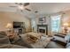 Cozy living room with a stone fireplace, a large window, and plush seating for relaxing with Gathering at 5045 Edinborough Pl, Sugar Hill, GA 30518