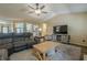 Inviting living room featuring an open floor plan, hardwood floors, and a comfortable seating area perfect for entertaining at 5045 Edinborough Pl, Sugar Hill, GA 30518