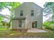 A spacious backyard with a concrete patio and the home's rear facade at 744 Brittany Ct, Stone Mountain, GA 30083