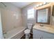 Bright bathroom featuring a vanity, toilet, and a tiled shower-over-tub combination at 744 Brittany Ct, Stone Mountain, GA 30083