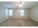 Well-lit bedroom features plush carpet, natural light and a ceiling fan at 744 Brittany Ct, Stone Mountain, GA 30083