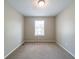 This cozy bedroom features neutral walls, a plush carpet, and a bright window at 744 Brittany Ct, Stone Mountain, GA 30083
