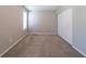 This carpeted bedroom includes a closet and a large window at 744 Brittany Ct, Stone Mountain, GA 30083