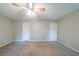 Bright bedroom features plush carpet, multiple doors, a ceiling fan, and neutral tones at 744 Brittany Ct, Stone Mountain, GA 30083