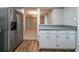 Open kitchen layout with stainless steel refrigerator and view to other rooms at 744 Brittany Ct, Stone Mountain, GA 30083