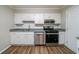Bright kitchen showcasing stainless steel appliances, white cabinetry, and modern countertops at 744 Brittany Ct, Stone Mountain, GA 30083