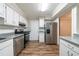 Updated kitchen featuring stainless steel appliances, white cabinets, and hard wood floors at 744 Brittany Ct, Stone Mountain, GA 30083