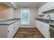 Charming kitchen featuring white cabinets, laminate countertops, and ample natural light at 744 Brittany Ct, Stone Mountain, GA 30083