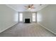 Spacious living room with fireplace, neutral paint, and plush carpeting at 744 Brittany Ct, Stone Mountain, GA 30083