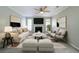 Bright living room with ceiling fan, fireplace, neutral walls and flooring, and contemporary furniture at 744 Brittany Ct, Stone Mountain, GA 30083